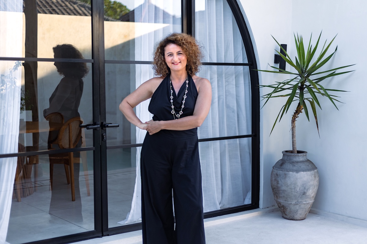 Dijan by a glass door with reflection